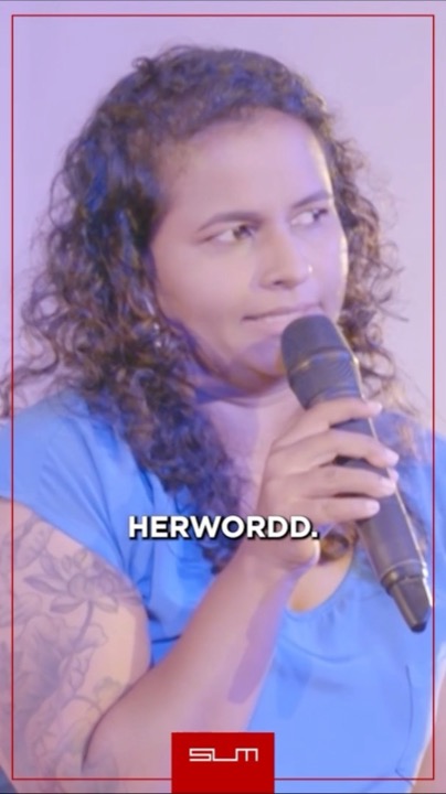 Dilini Perera performing stand-up with a microphone