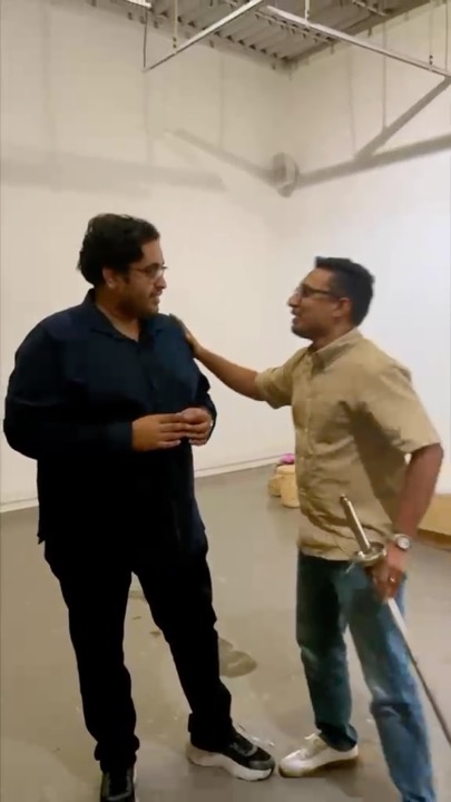 Two people talking in a foyer during a mock job interview