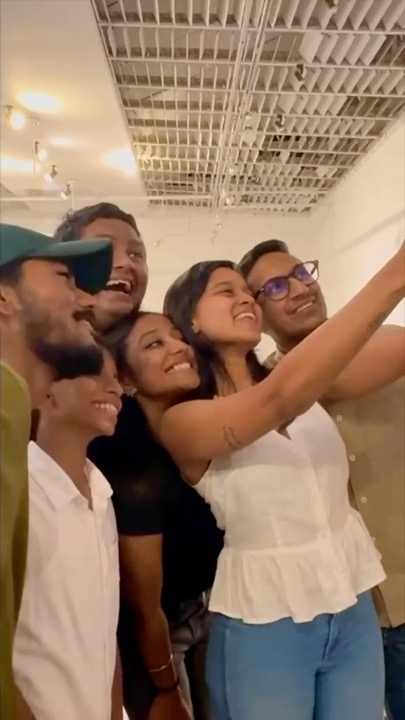 Cast members crowded into a side room taking a group selfie