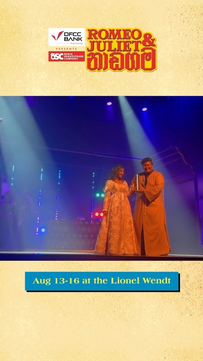 Juliet and Friar Lawrence on stage under blue light